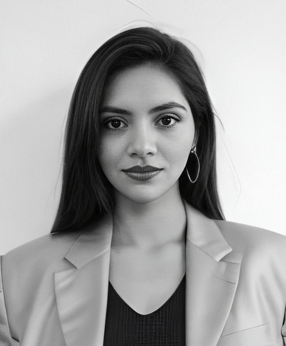 Professional portrait of a woman architect with glasses holding plans